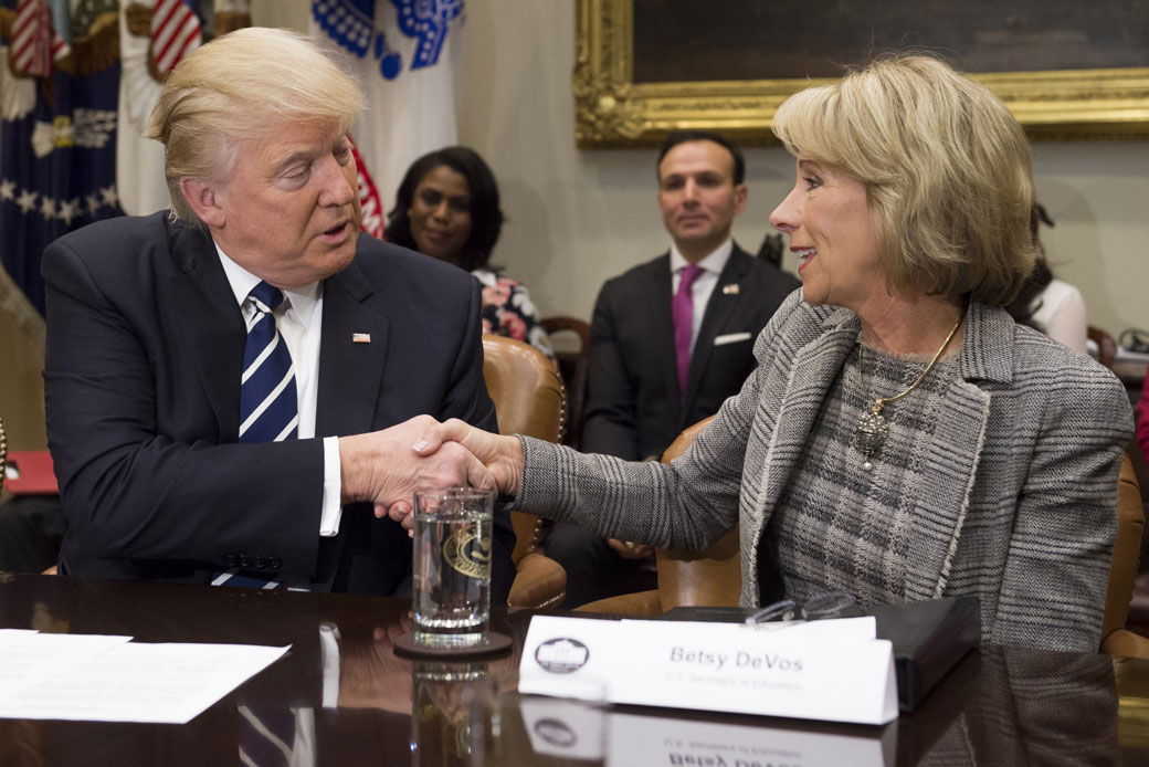 Education Secretary Betsy DeVos shakes hands with President Donald Trump during a White House meeting, February 2017. (Getty/Saul Loeb)