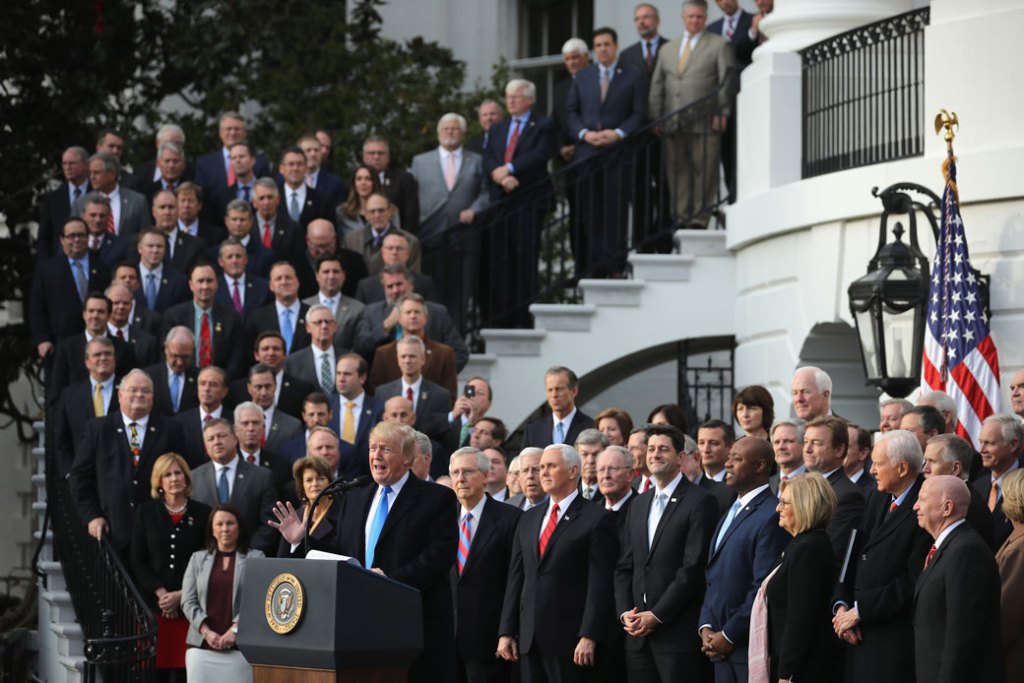 President Donald Trump, flanked by Republican lawmakers, celebrates Congress passing the Tax Cuts and Jobs Act on the South Lawn of the White House on December 20, 2017. (Getty/Chip Somodevilla)