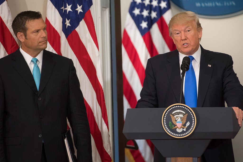 President Donald Trump speaks alongside then-Kansas Secretary of State Kris Kobach (L) during the first meeting of the Presidential Advisory Commission on Election Integrity in Washington, D.C., July 19, 2017. (Getty/Saul Loeb)