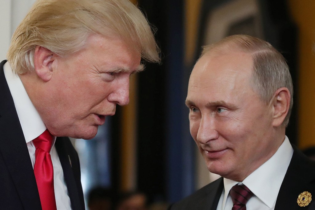 President Donald Trump chats with Russian President Vladimir Putin, November 2017. (Getty/Mikhail Klimentyev)