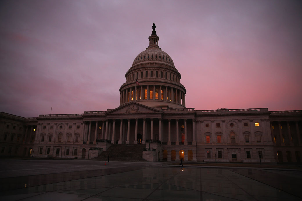 The morning sun rises behind the U.S. Capitol in Washington, D.C., March 2014. (Getty/Mark Wilson)