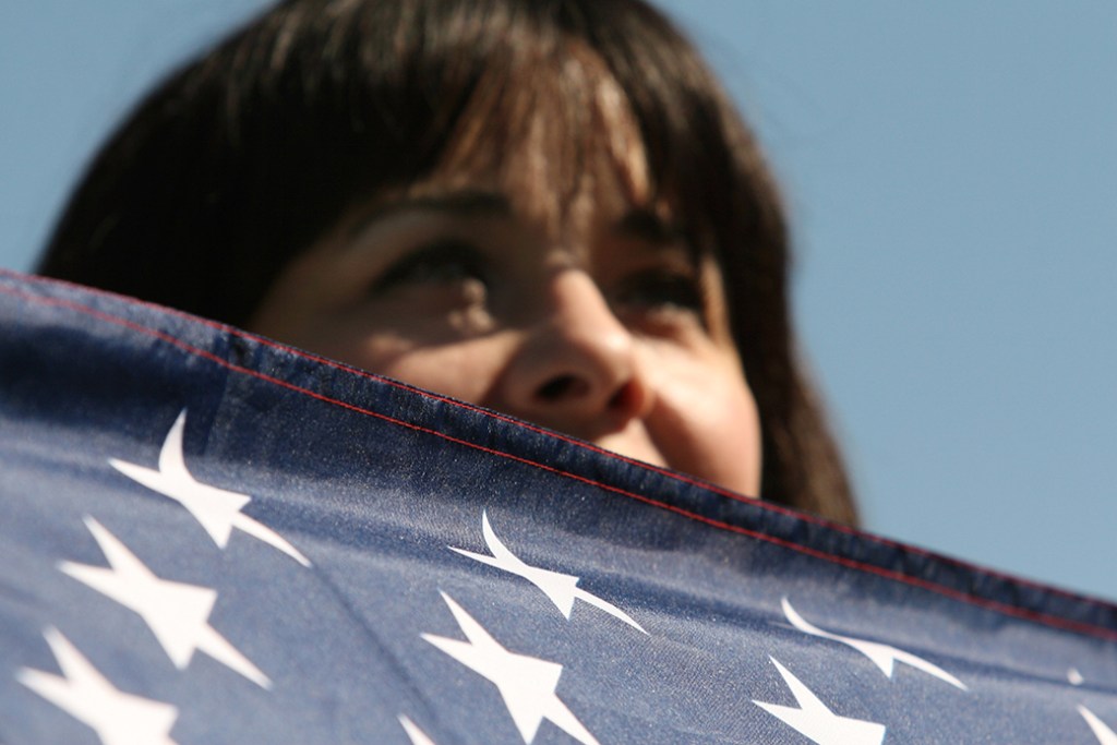 A person with an American flag participates in a march in Washington, D.C., October 2010. (Getty/Logan Mock-Bunting)