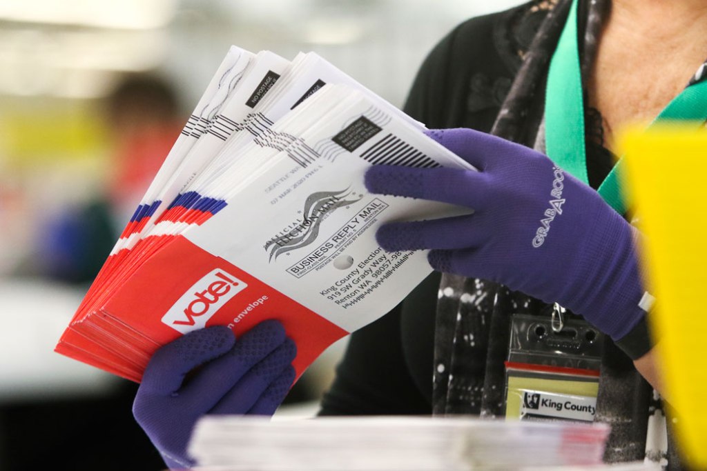 An election worker in Renton, Washington, sorts vote-by-mail ballots for the presidential primary, March 2020. (Getty/AFP/Jason Redmond)