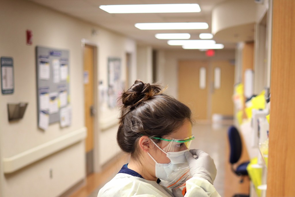 A nurse in the COVID-19 unit of a Maryland hospital checks the fit of protective equipment before entering a patient's room, March 2020. (Getty/Win McNamee)