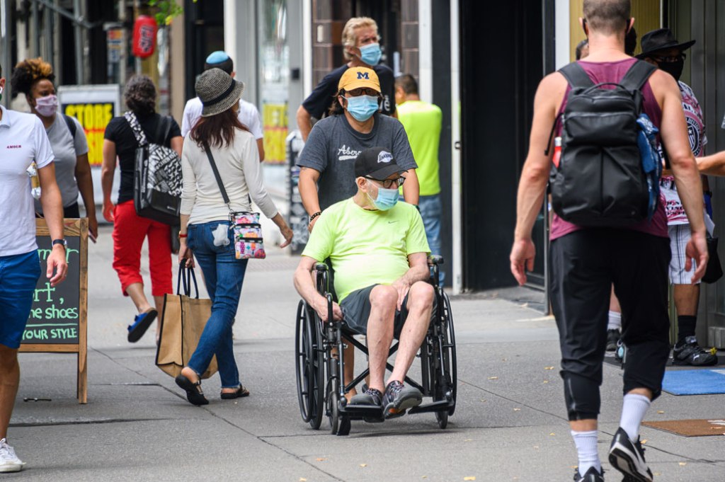 People wear protective face masks as New York City begins reopening following restrictions imposed to curb the coronavirus pandemic on July 7, 2020. (Getty/Noam Galai)