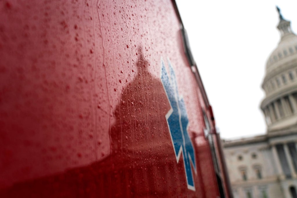 The U.S. Capitol Building is reflected against the side of an ambulance in Washington, D.C., March 2020. (Getty/AFP/Alex Edelman)