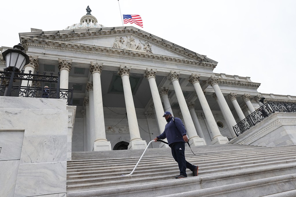 A worker cleans steps prior to the arrival of the casket of late Supreme Court Associate Justice Ruth Bader Ginsburg at the U.S. Capitol, September 2020, in Washington. (Getty/Jonathan Ernst-Pool)