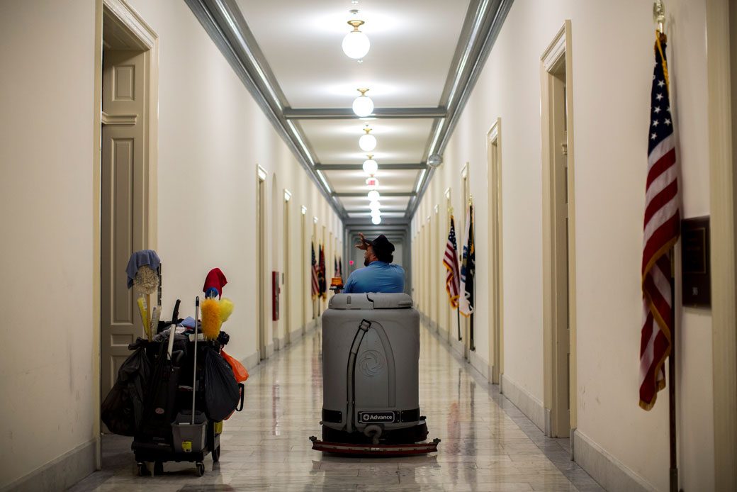  (A custodial worker buffs the marble floors of the Cannon House Office Building in the U.S. Capitol in Washington, D.C., March 2015.)
