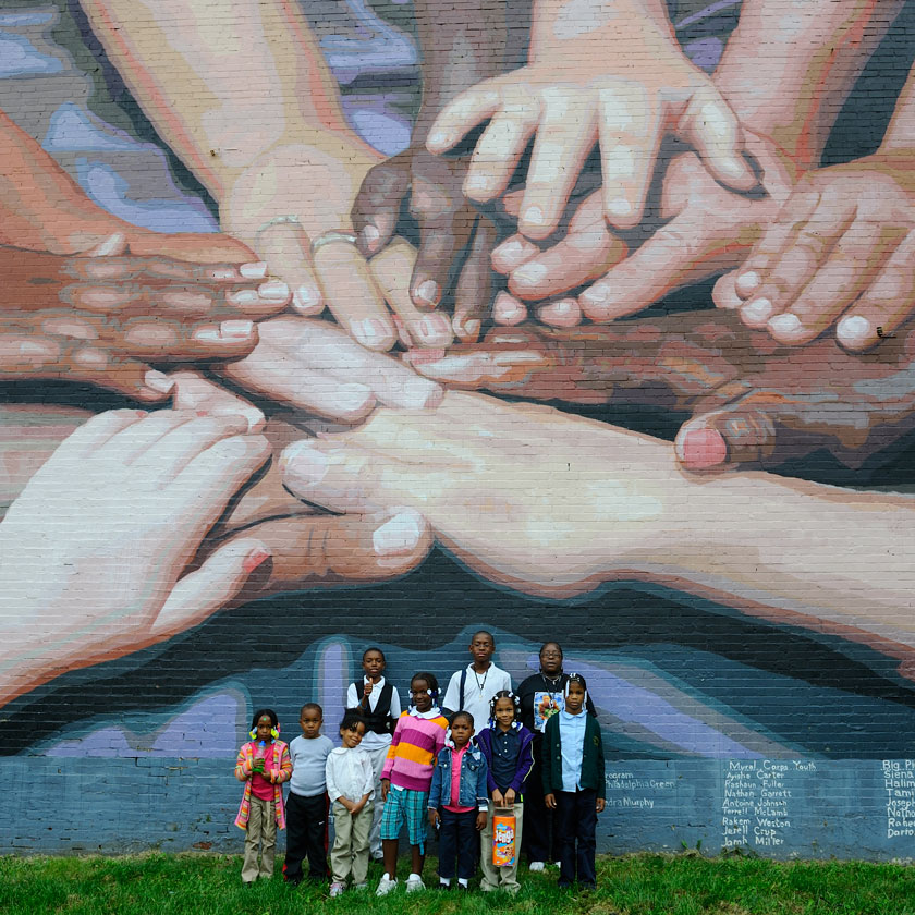 People stand before a mural honoring people of peace in a Black district in Philadelphia on September 15, 2013. (Getty/Frédéric Soltan) 