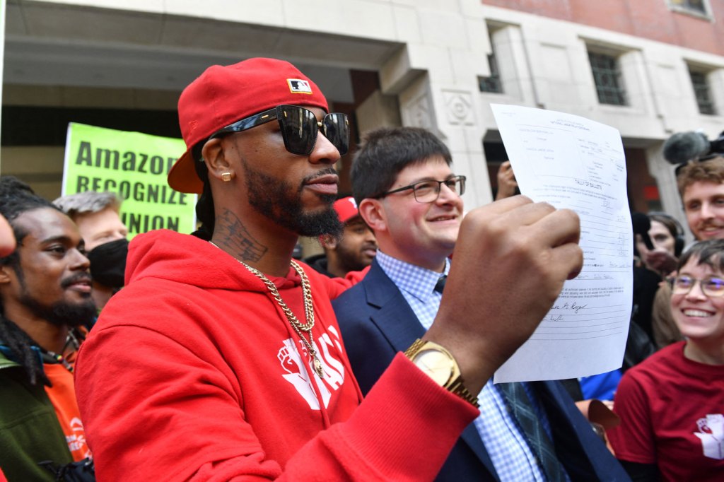 Union organizer Christian Smalls celebrates with Amazon workers following the April 1, 2022, vote for the unionization of the Amazon Staten Island warehouse in New York.