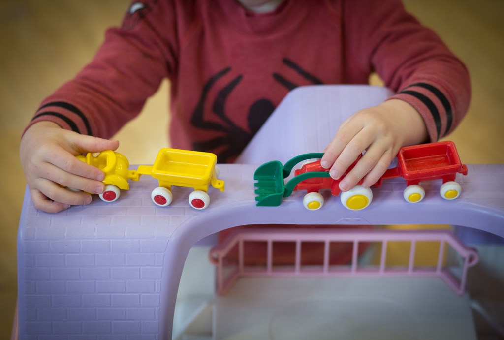 Close-up on hands playing with toys