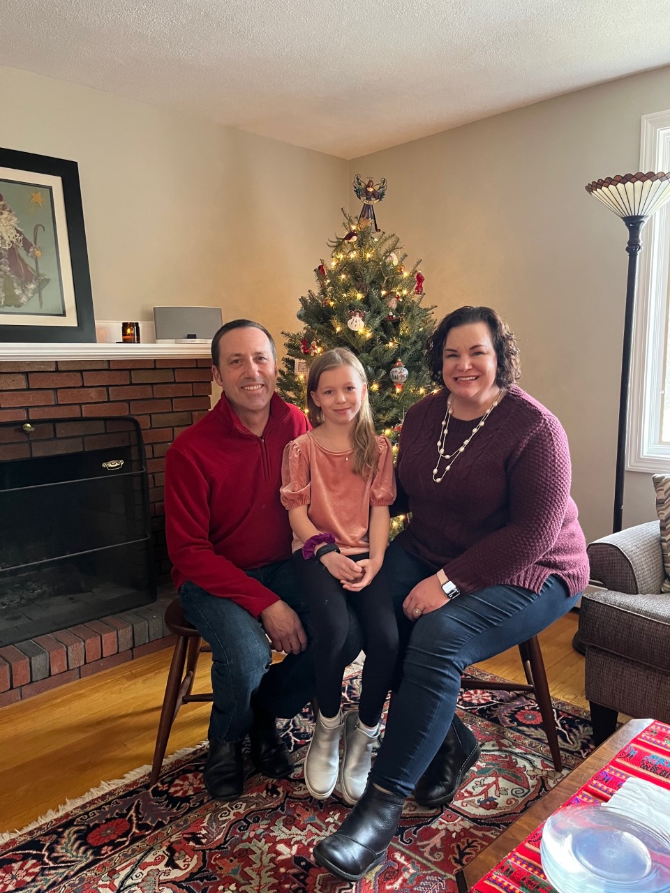 Margaret Langsenkamp sits with her husband, Lee, and daughter, Louelle, in December 2021.