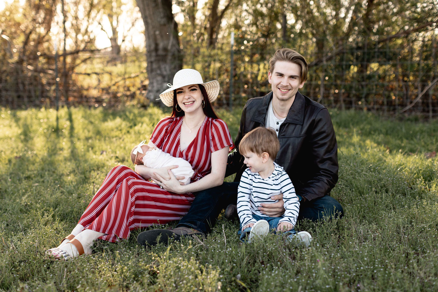 Julia Callahan sits with her fiance, Nathan, and their daughter, Berlin, and son, Boston, in April 2022. (Photo credit: Mary Beth Wood) 