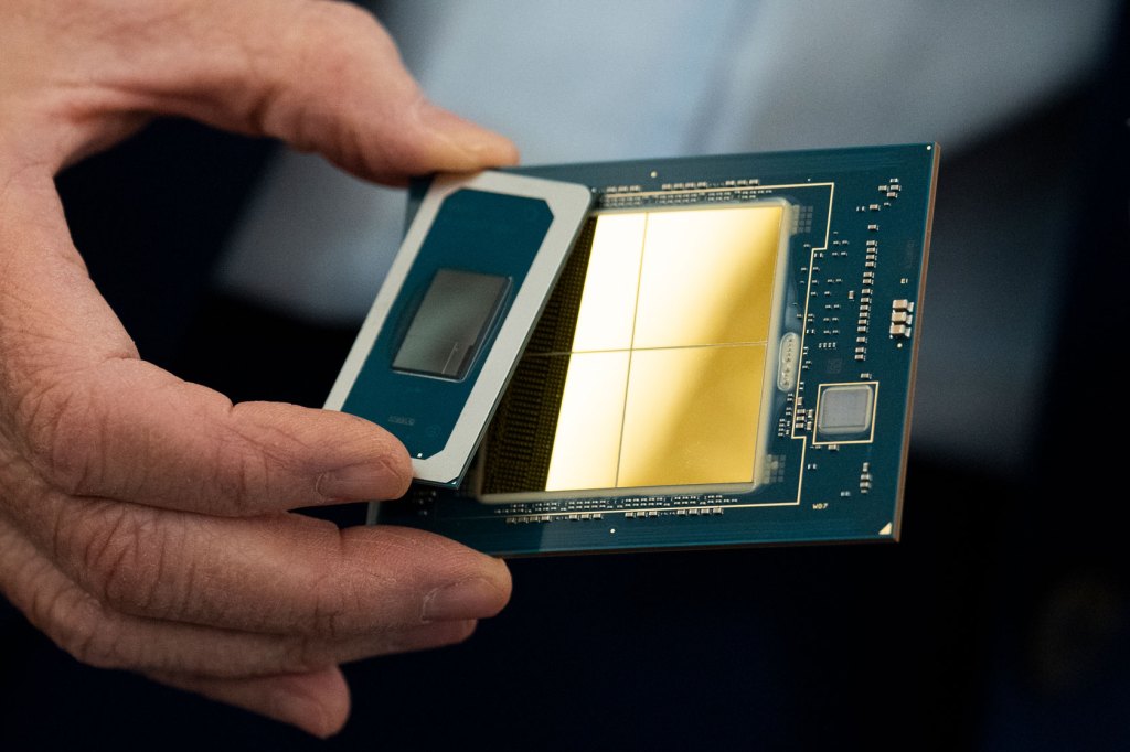 Photo shows a hand holding a semiconductor chip.