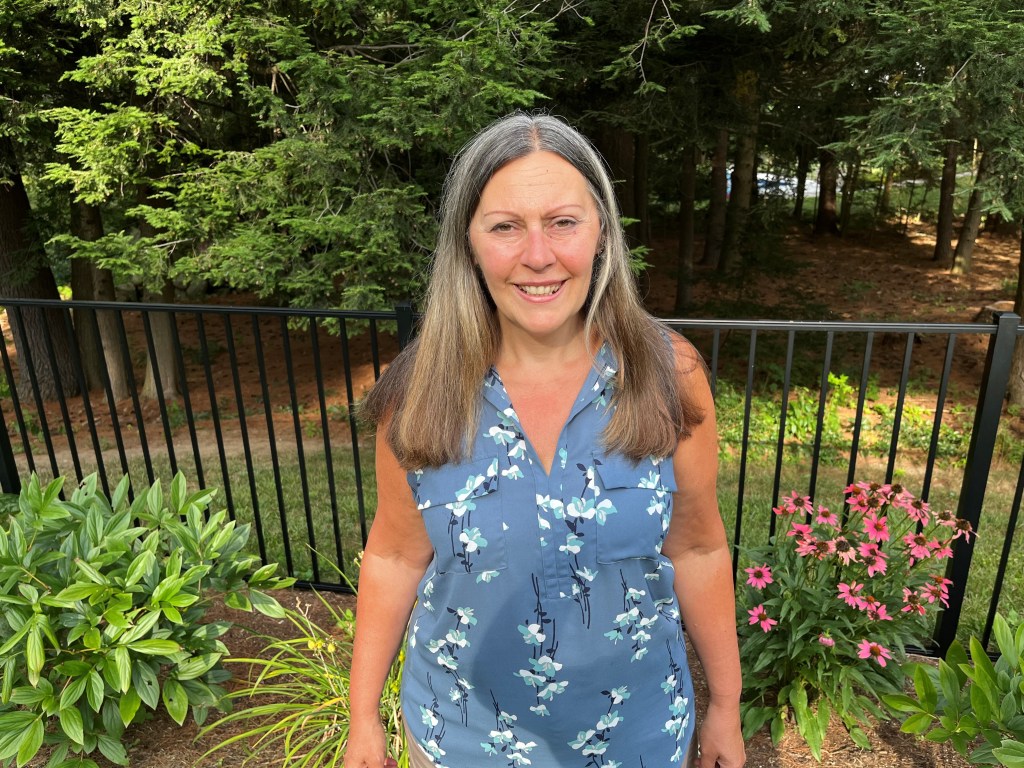 Laurene Allen stands before her garden.