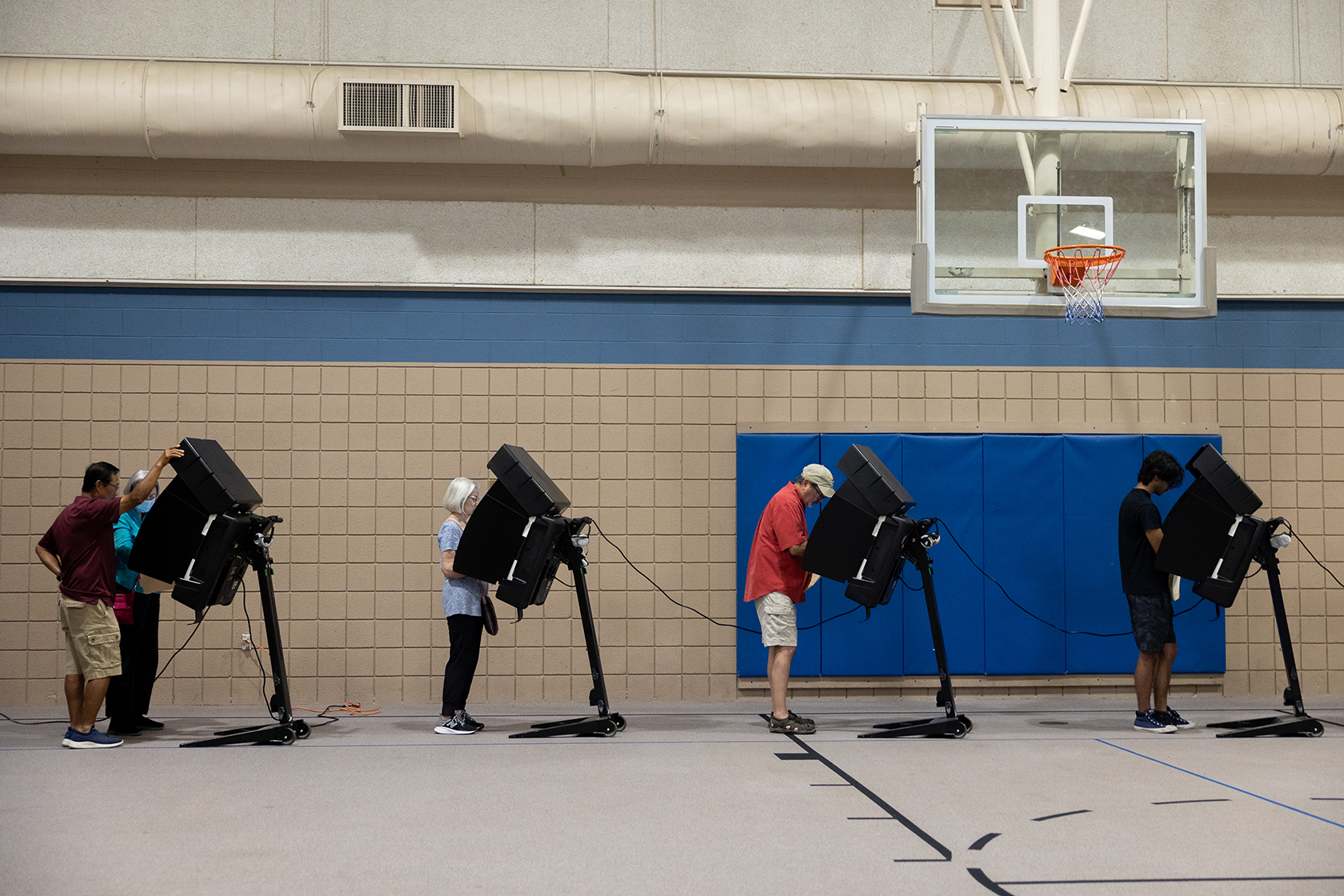 People standing at voting machines