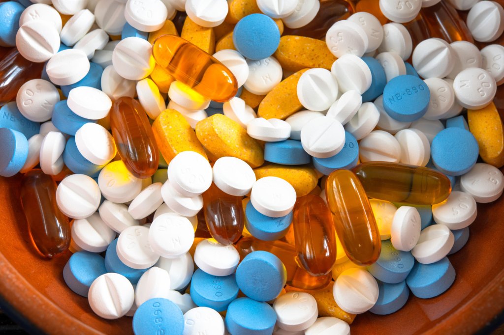 A multi-colored bowl of pills is seen.