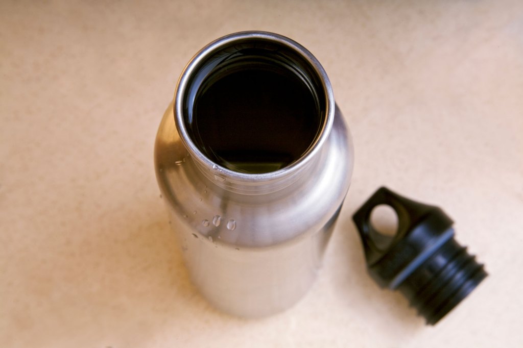 A full stainless steel water bottle is seen from above.