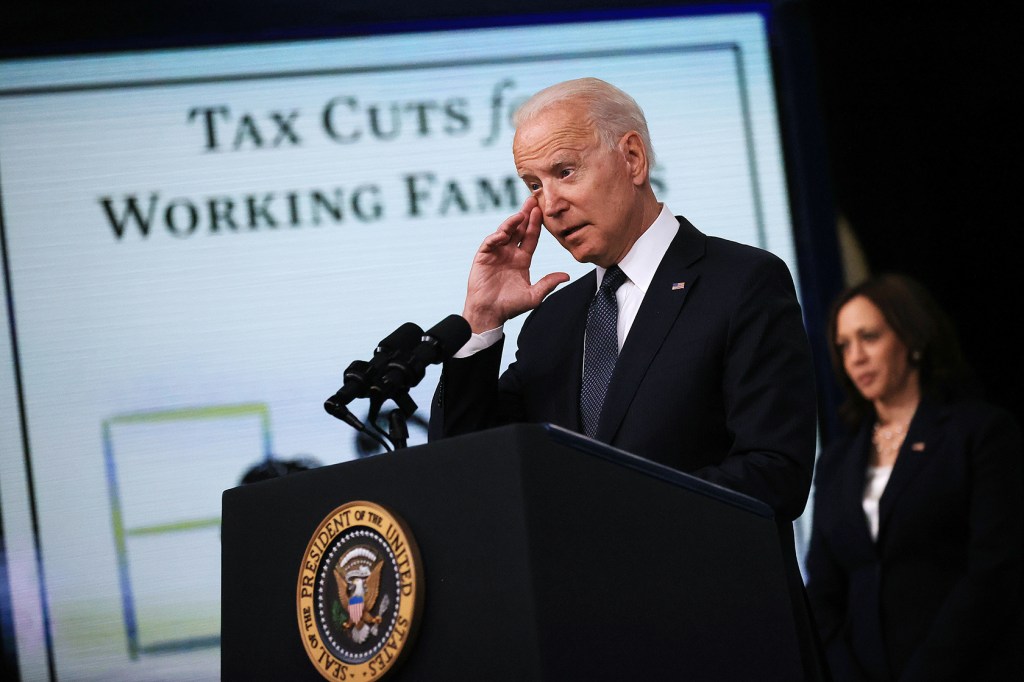 President Biden at podium; Vice President Harris standing behind; sign reading Tax Cuts for Working Families in background