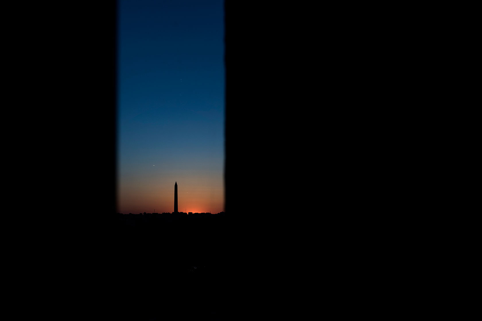 A view of the Washington Monument is seen at sunset amid Affordable Care Act negotiations.