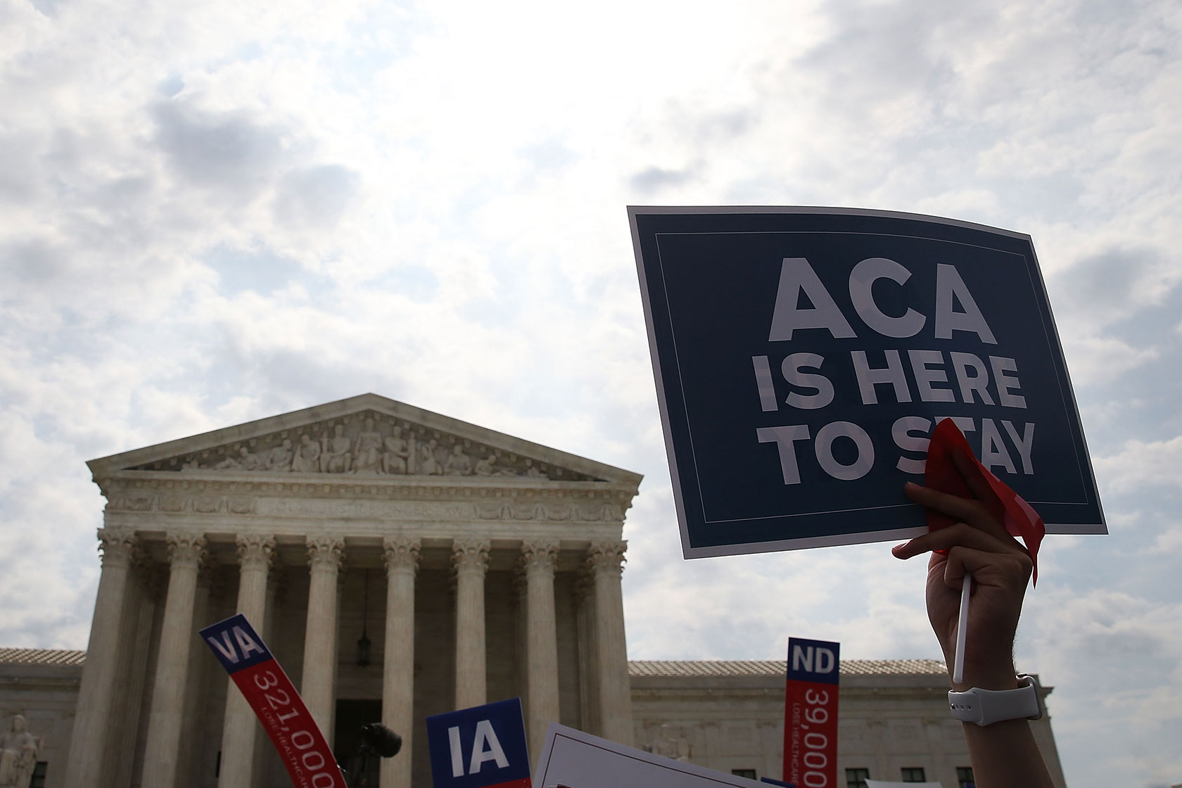 A sign is held up during a rally for the Affordable Care Act.