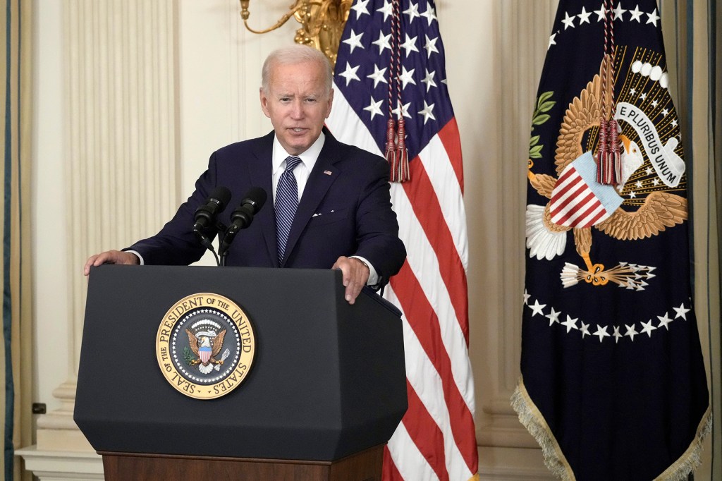 President Joe Biden standing behind podium