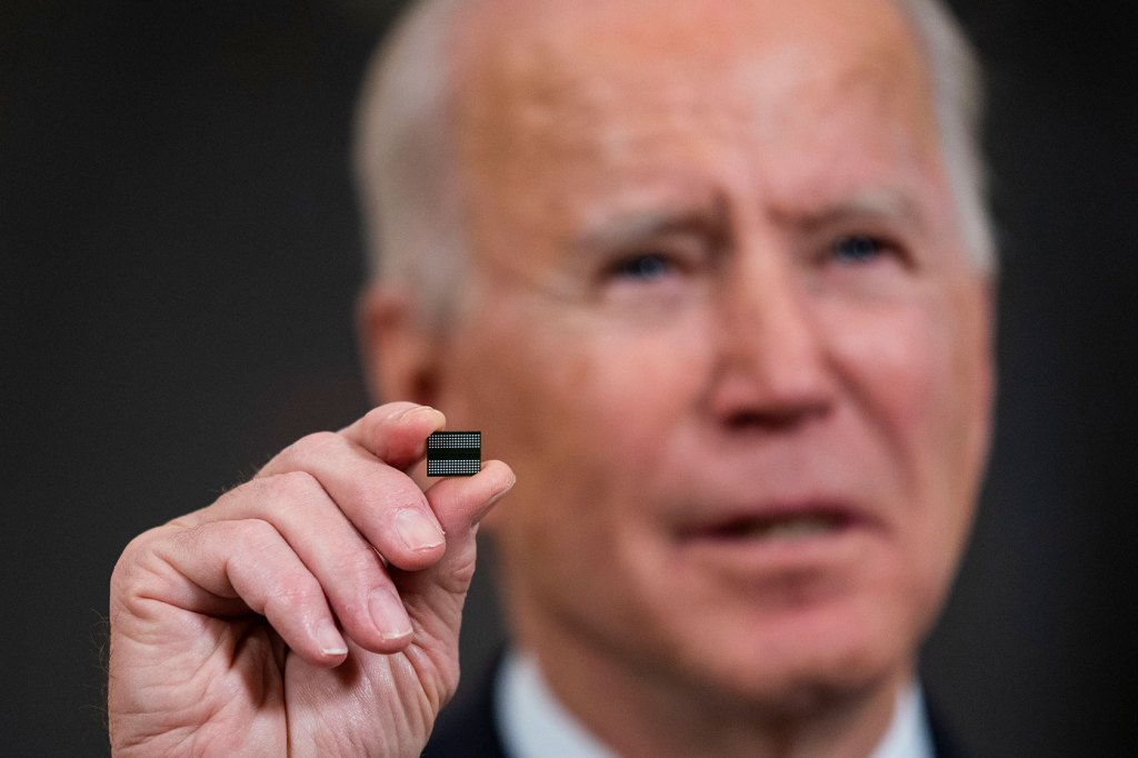 U.S. President Joe Biden holds a semiconductor during his remarks before signing an executive order.