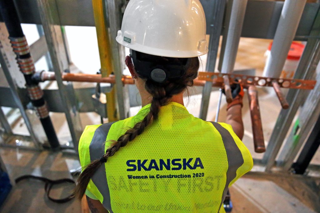 A female construction worker is seen at work.