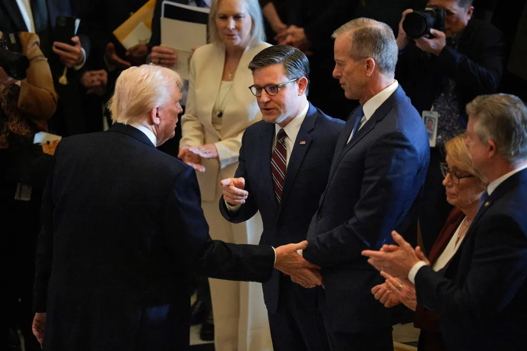U.S. President Donald Trump shakes hands with House Speaker Rep. Mike Johnson (R-LA) and Senate Majority Leader John Thune (R-SD).